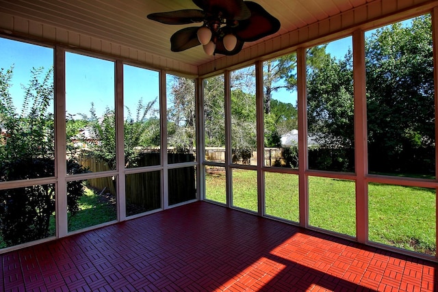 unfurnished sunroom with ceiling fan and wooden ceiling