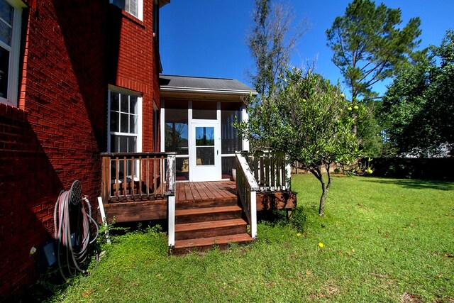 view of yard with a deck and a sunroom