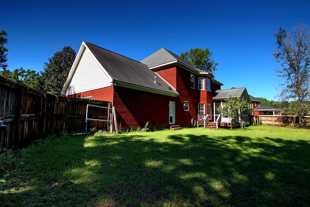 rear view of property with a lawn