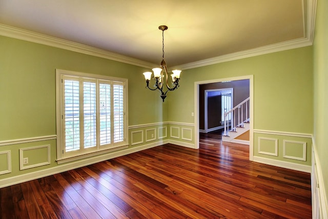 unfurnished room featuring dark hardwood / wood-style flooring, an inviting chandelier, and ornamental molding