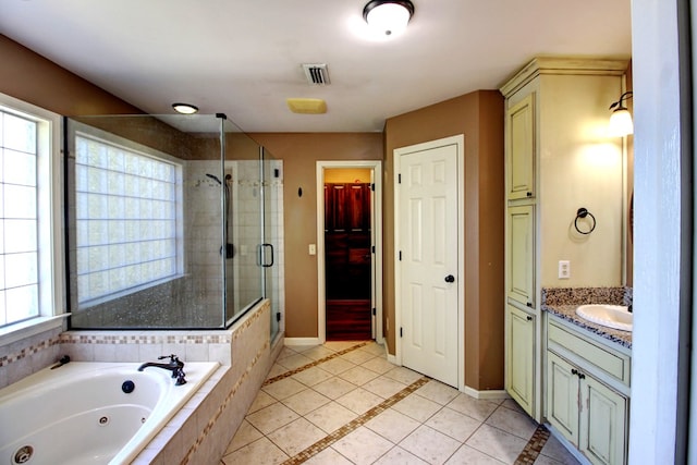 bathroom with tile patterned floors, vanity, and independent shower and bath