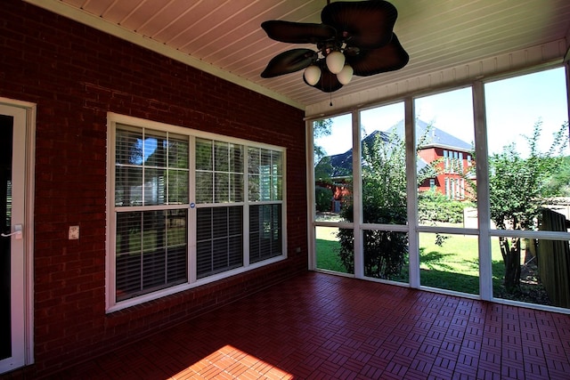 unfurnished sunroom featuring ceiling fan