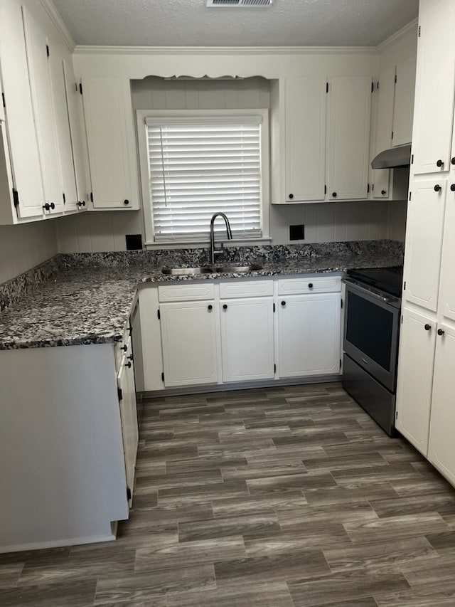 kitchen featuring white cabinets, a textured ceiling, electric range, and sink