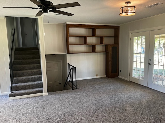 unfurnished living room with carpet flooring, crown molding, and french doors