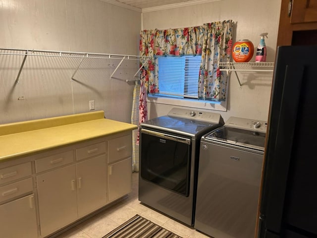 555 Cove Rd, Abbeville, AL 36310 - washroom featuring independent washer and dryer, crown molding, cabinet space, and light tile patterned floors