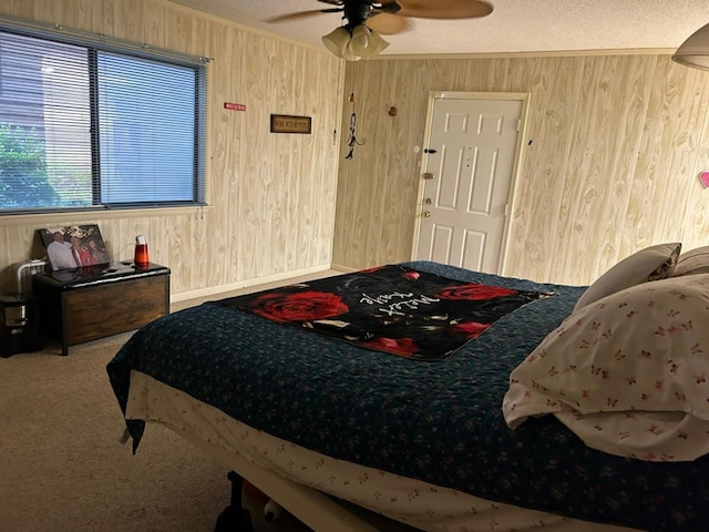 555 Cove Rd, Abbeville, AL 36310 - carpeted bedroom with crown molding, wood walls, a ceiling fan, and a textured ceiling