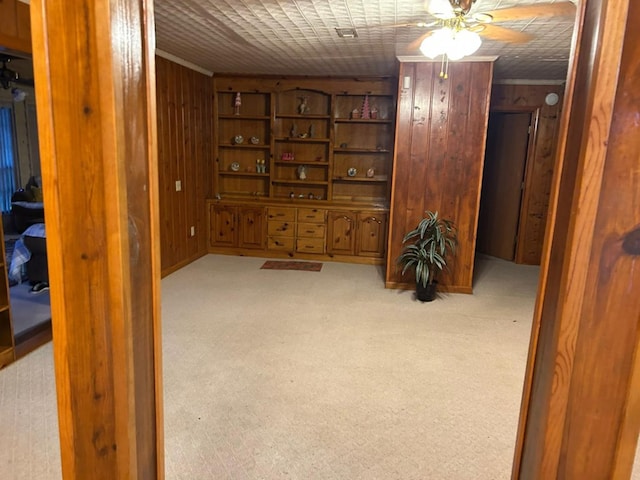 555 Cove Rd, Abbeville, AL 36310 - below grade area featuring wood walls, a ceiling fan, and light colored carpet