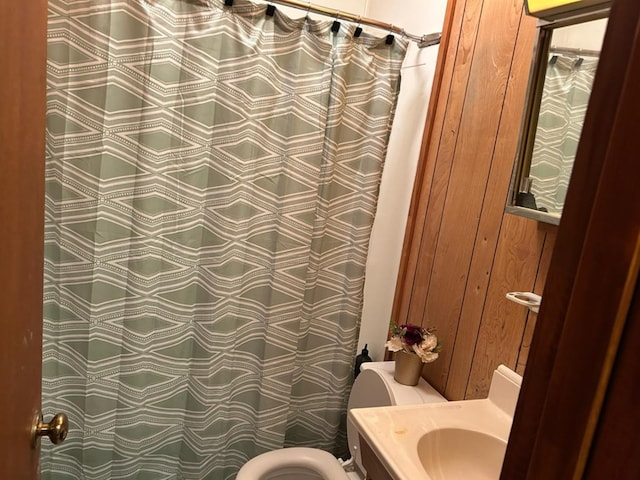 555 Cove Rd, Abbeville, AL 36310 - full bathroom featuring toilet, wooden walls, vanity, and curtained shower
