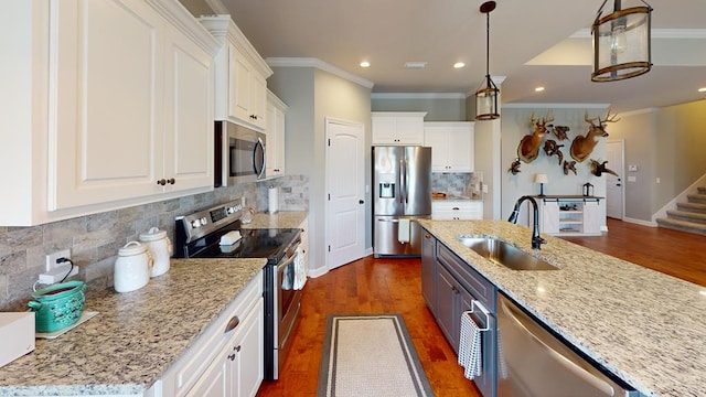 kitchen featuring sink, stainless steel appliances, dark hardwood / wood-style floors, pendant lighting, and white cabinets