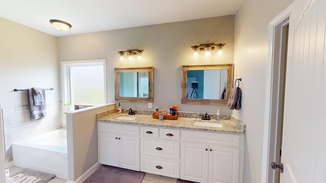 bathroom with tile patterned floors, vanity, and a bathtub