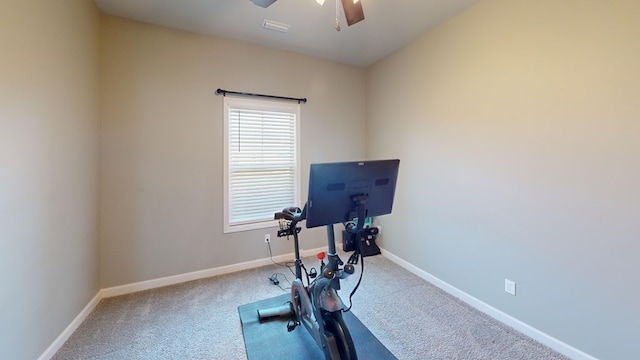 workout area with ceiling fan and carpet