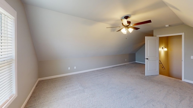 additional living space with ceiling fan, carpet floors, and lofted ceiling