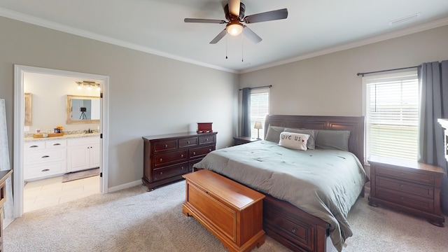 bedroom featuring light carpet, ensuite bath, ceiling fan, and ornamental molding