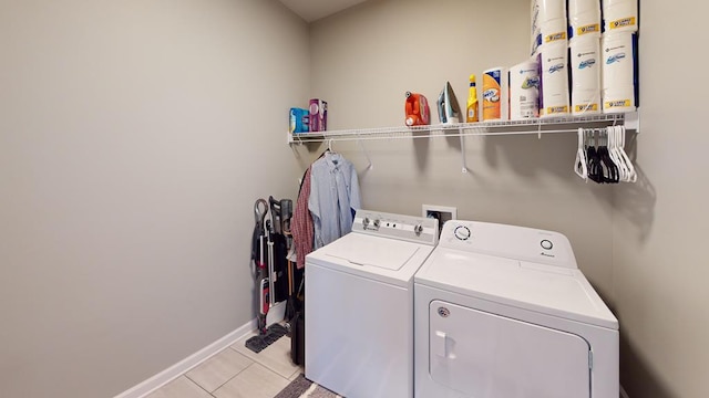 laundry room with light tile patterned floors and washing machine and clothes dryer