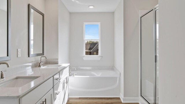 109 Creekridge St, Headland, AL 36345 - full bath featuring a shower stall, a bath, a sink, and wood finished floors