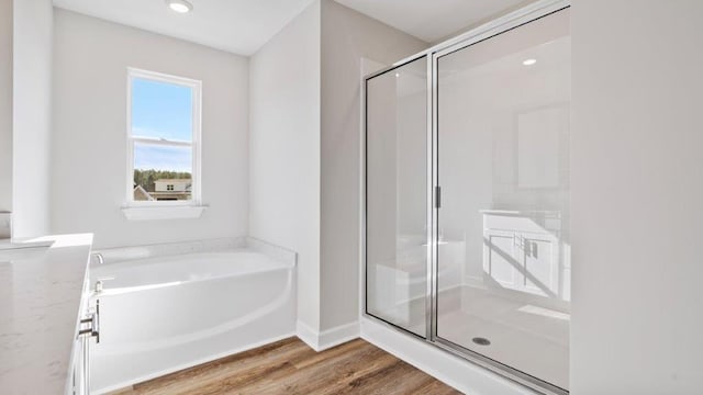 109 Creekridge St, Headland, AL 36345 - full bath featuring a garden tub, a shower stall, and wood finished floors