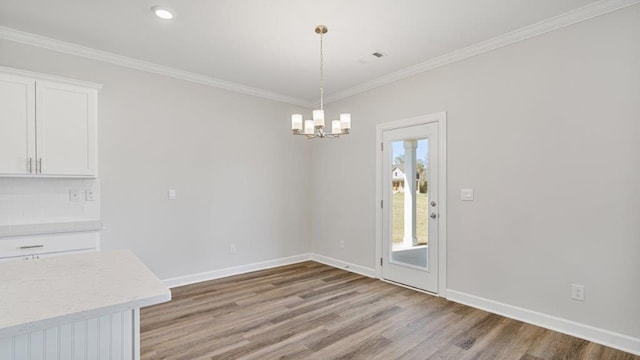 109 Creekridge St, Headland, AL 36345 - unfurnished dining area with light wood finished floors, an inviting chandelier, baseboards, ornamental molding, and recessed lighting