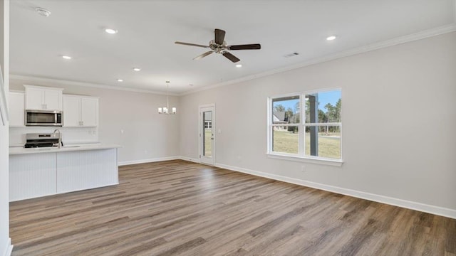 109 Creekridge St, Headland, AL 36345 - unfurnished living room with recessed lighting, baseboards, ornamental molding, ceiling fan with notable chandelier, and wood finished floors