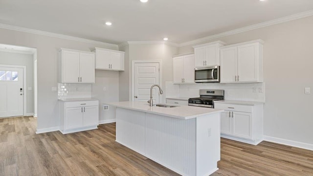 109 Creekridge St, Headland, AL 36345 - kitchen with a sink, white cabinets, a kitchen island with sink, stainless steel appliances, and tasteful backsplash