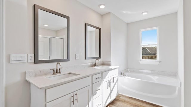109 Creekridge St, Headland, AL 36345 - bathroom featuring a stall shower, a garden tub, double vanity, and a sink