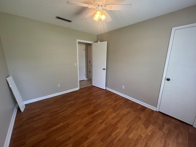 411 Kentworth Dr, Dothan, AL 36301 - unfurnished bedroom featuring wood finished floors, a textured ceiling, and a ceiling fan