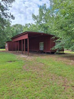 view of outbuilding featuring a lawn