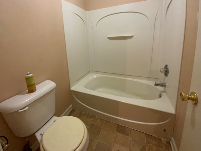 full bath featuring baseboards, toilet, and tub / shower combination