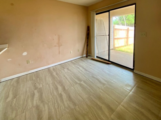 spare room with baseboards