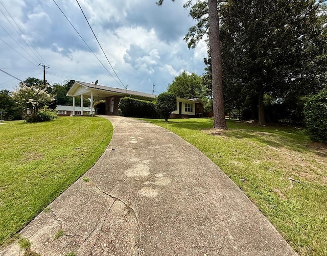 300 Mixson St, Enterprise, AL 36330 - view of front of home featuring concrete driveway, a front yard, and a carport