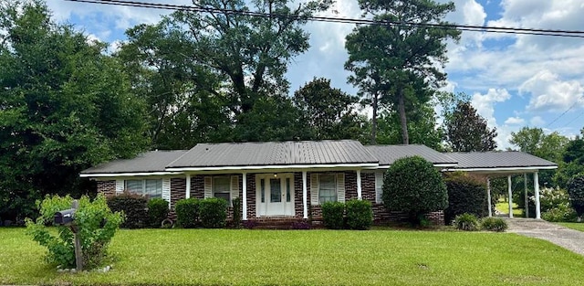 300 Mixson St, Enterprise, AL 36330 - ranch-style home featuring a front yard, an attached carport, covered porch, driveway, and a metal roof