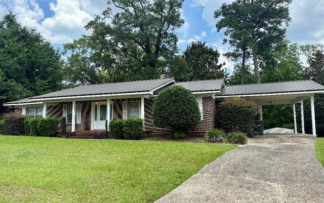 300 Mixson St, Enterprise, AL 36330 - ranch-style house with a front yard, covered porch, an attached carport, driveway, and a metal roof