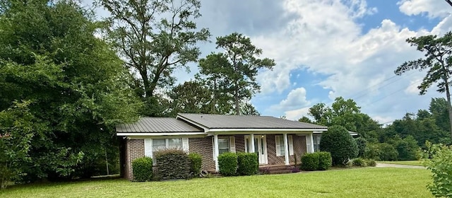 300 Mixson St, Enterprise, AL 36330 - view of front of house with a front yard, brick siding, and a metal roof