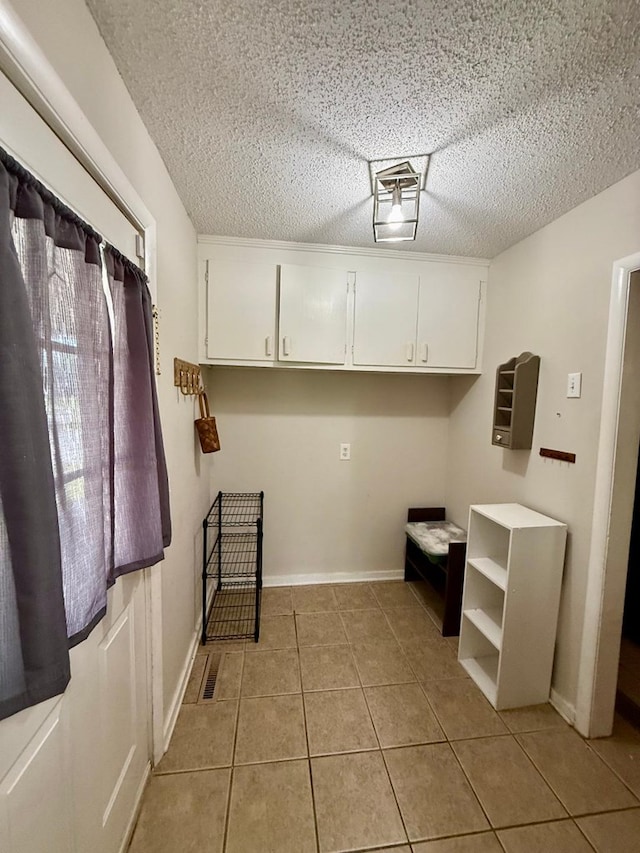 300 Mixson St, Enterprise, AL 36330 - laundry area with light tile patterned floors and a textured ceiling