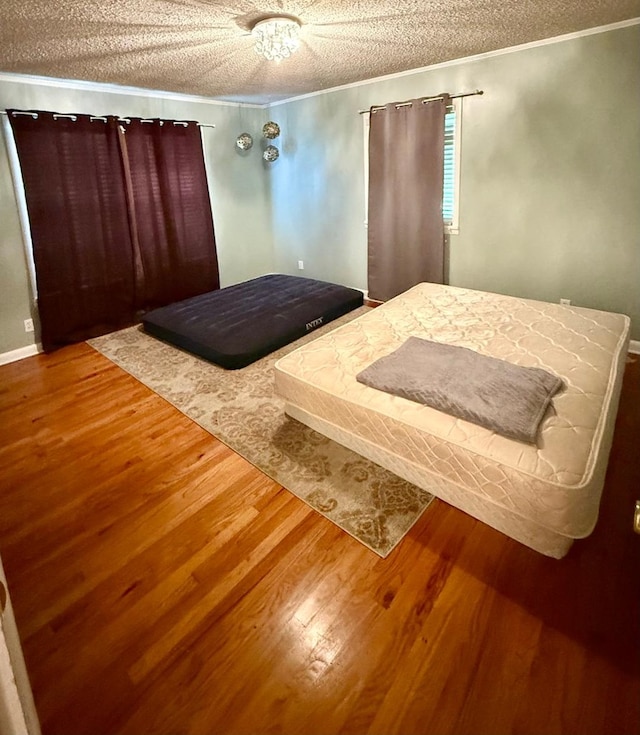 300 Mixson St, Enterprise, AL 36330 - bedroom with wood finished floors, a textured ceiling, and crown molding