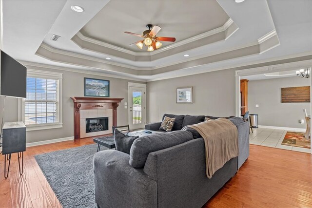 102 Tumbleweed Dr, Enterprise, AL 36330 - living area featuring ornamental molding, a raised ceiling, healthy amount of natural light, a ceiling fan, and a tiled fireplace