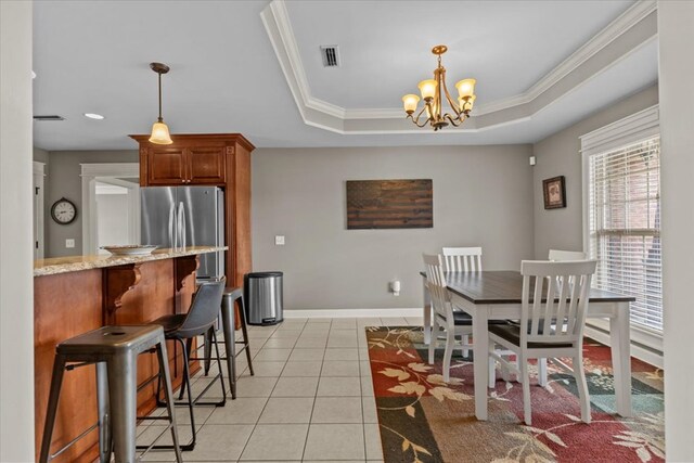 102 Tumbleweed Dr, Enterprise, AL 36330 - dining area with light tile patterned flooring, a raised ceiling, a chandelier, and ornamental molding