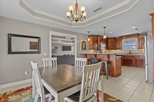 102 Tumbleweed Dr, Enterprise, AL 36330 - dining area with a chandelier, light tile patterned floors, a raised ceiling, and crown molding