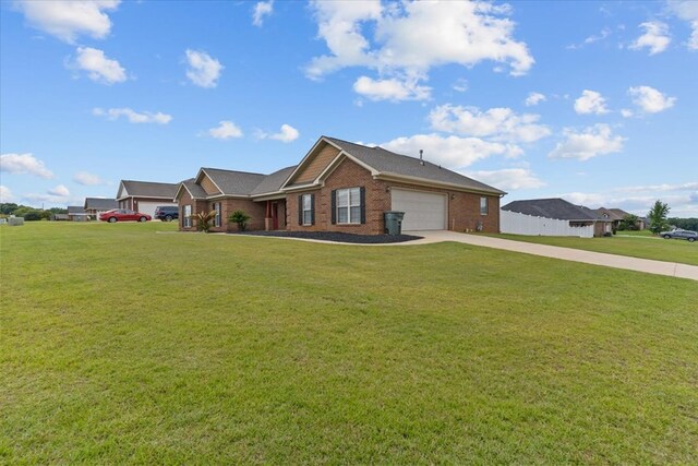 102 Tumbleweed Dr, Enterprise, AL 36330 - ranch-style house with driveway, a garage, brick siding, and a front lawn