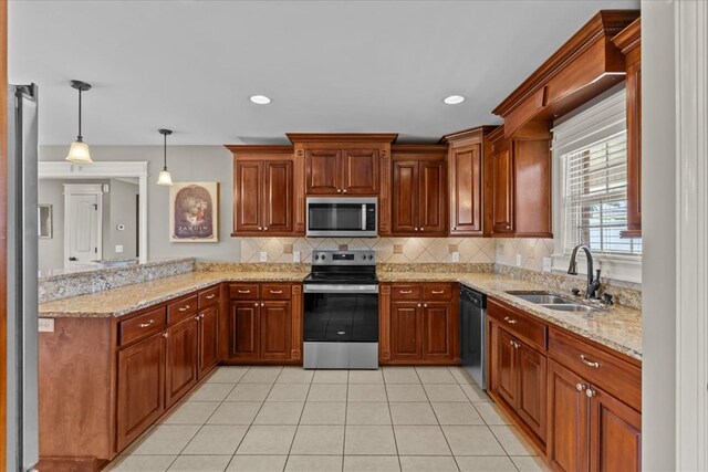 102 Tumbleweed Dr, Enterprise, AL 36330 - kitchen with stainless steel appliances, a peninsula, light tile patterned floors, tasteful backsplash, and light stone counters