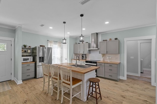 3155 Eddins Rd, Dothan, AL 36301 - kitchen featuring gray cabinetry, wall chimney exhaust hood, white microwave, stainless steel refrigerator with ice dispenser, and wooden counters