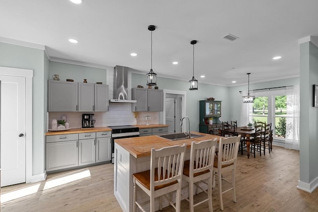3155 Eddins Rd, Dothan, AL 36301 - kitchen with electric range oven, wall chimney exhaust hood, gray cabinets, tasteful backsplash, and light wood-style floors