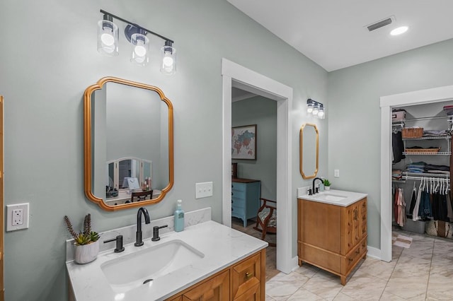 3155 Eddins Rd, Dothan, AL 36301 - full bathroom featuring marble look tiles, two vanities, and a walk in closet