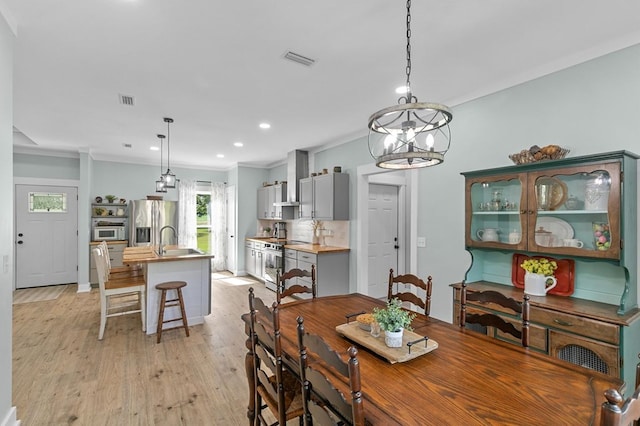 3155 Eddins Rd, Dothan, AL 36301 - dining space featuring light wood finished floors, ornamental molding, a chandelier, and recessed lighting