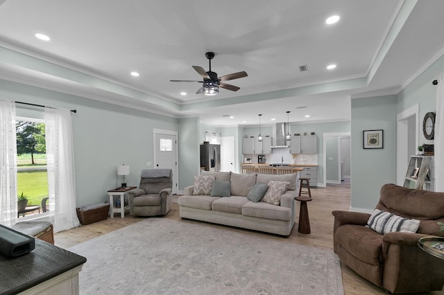 3155 Eddins Rd, Dothan, AL 36301 - living area featuring a tray ceiling, healthy amount of natural light, light wood-type flooring, recessed lighting, and crown molding