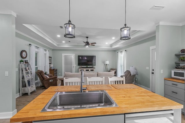 3155 Eddins Rd, Dothan, AL 36301 - kitchen featuring wooden counters, open floor plan, decorative light fixtures, ceiling fan, and crown molding