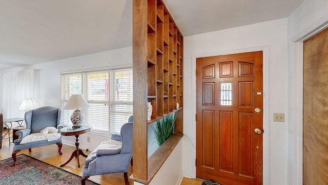 foyer with baseboards and wood finished floors