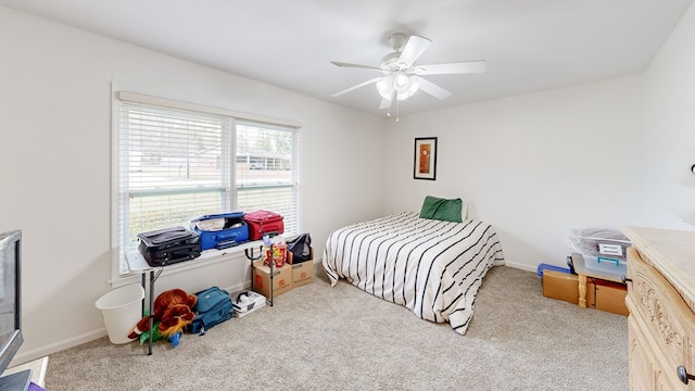 carpeted bedroom featuring baseboards and ceiling fan