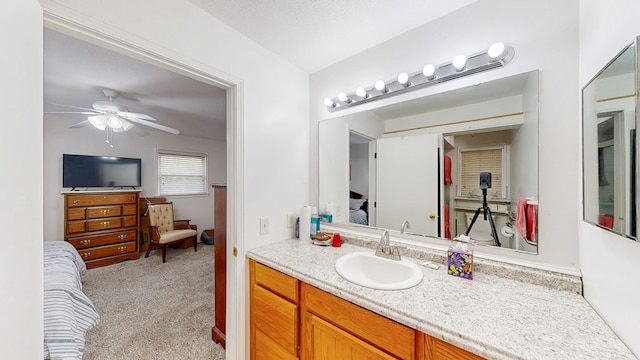 bathroom featuring vanity, a ceiling fan, and connected bathroom