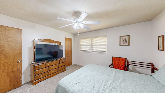 bedroom with baseboards, light colored carpet, ceiling fan, and a textured ceiling