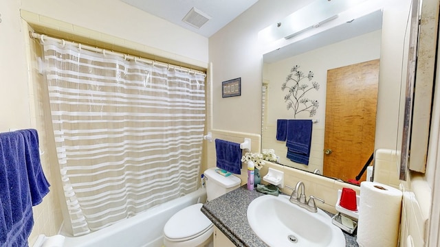 full bathroom with vanity, toilet, visible vents, and shower / tub combo with curtain